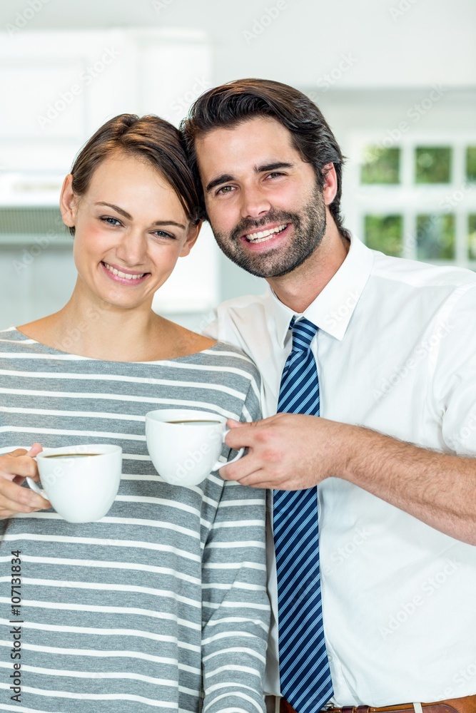 Smiling couple drinking coffee at home Smiling couple drinking coffee at home