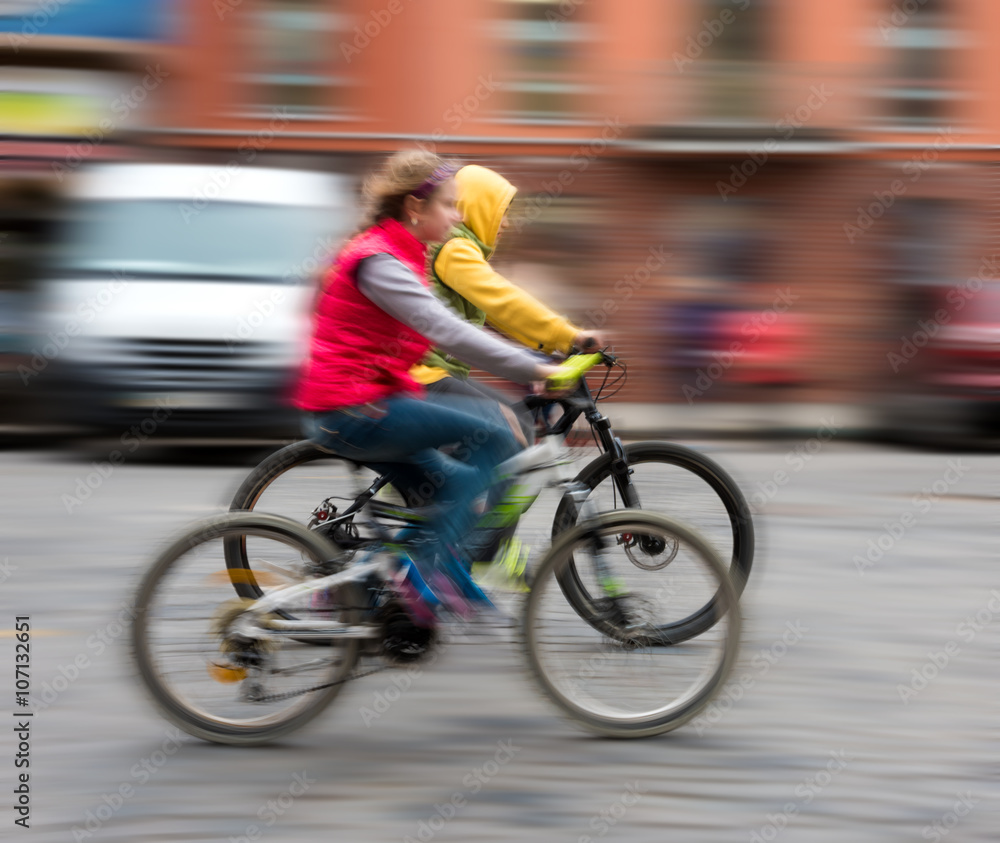 Children riding bicycles on a city street Children riding bicycles on a city street
