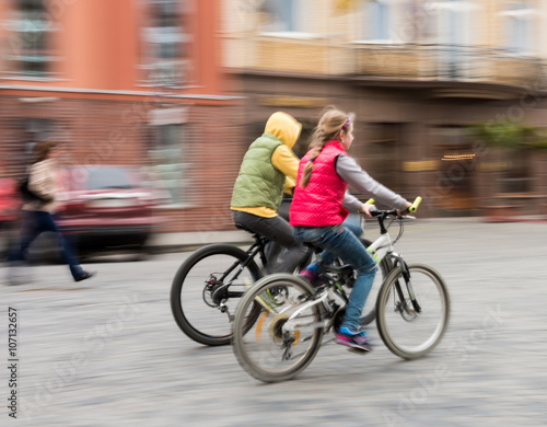 Children riding bicycles on a city street