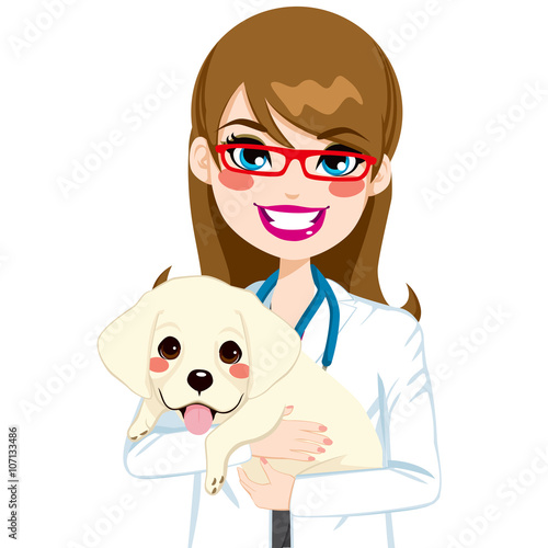 Beautiful young female veterinarian hugging cute little Labrador puppy