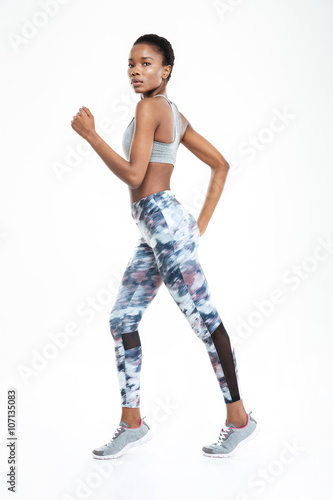 Full length portrait of afro american woman running