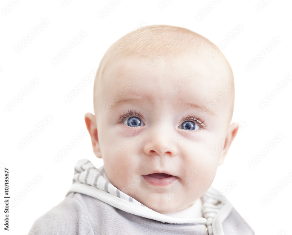 Baby with blue eyes looking to the camera and smiling, isolated