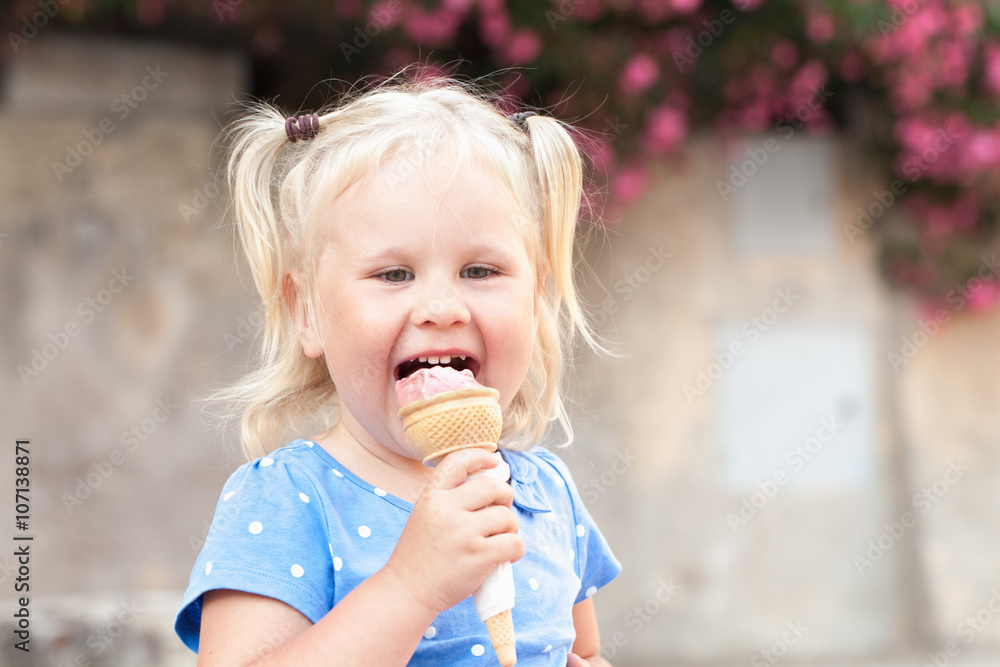 Little happy cheerful girl eats gelato, outdoor Little happy cheerful girl eats gelato, outdoor