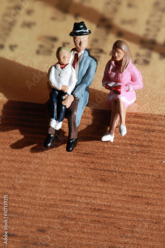Happy family (miniature) on the book.