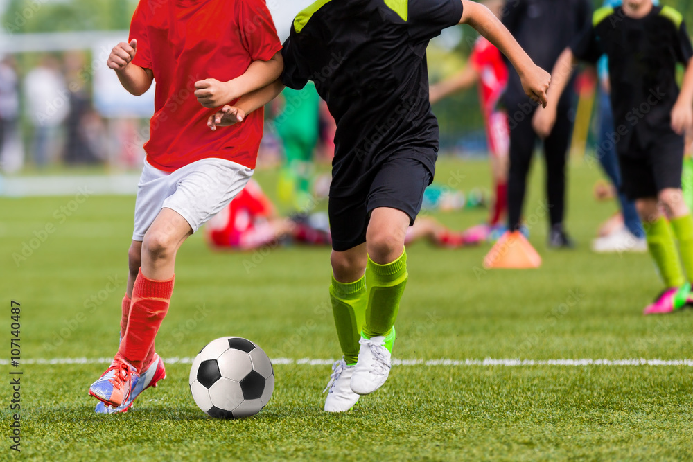 Young boys play soccer football match