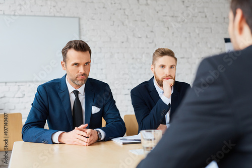 Business negotiations - three business man negotiating photo