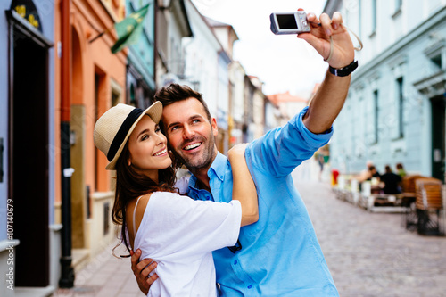 tourists couple taking selfie on city street