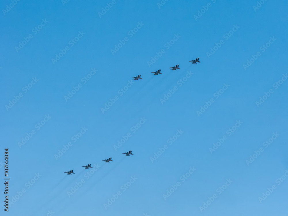 8 Mikoyan-Gurevich MiG-31 (Foxhound) supersonic interceptor aircrafts fly on blue sky background
8 Mikoyan-Gurevich MiG-31 (Foxhound) supersonic interceptor aircrafts fly on blue sky background