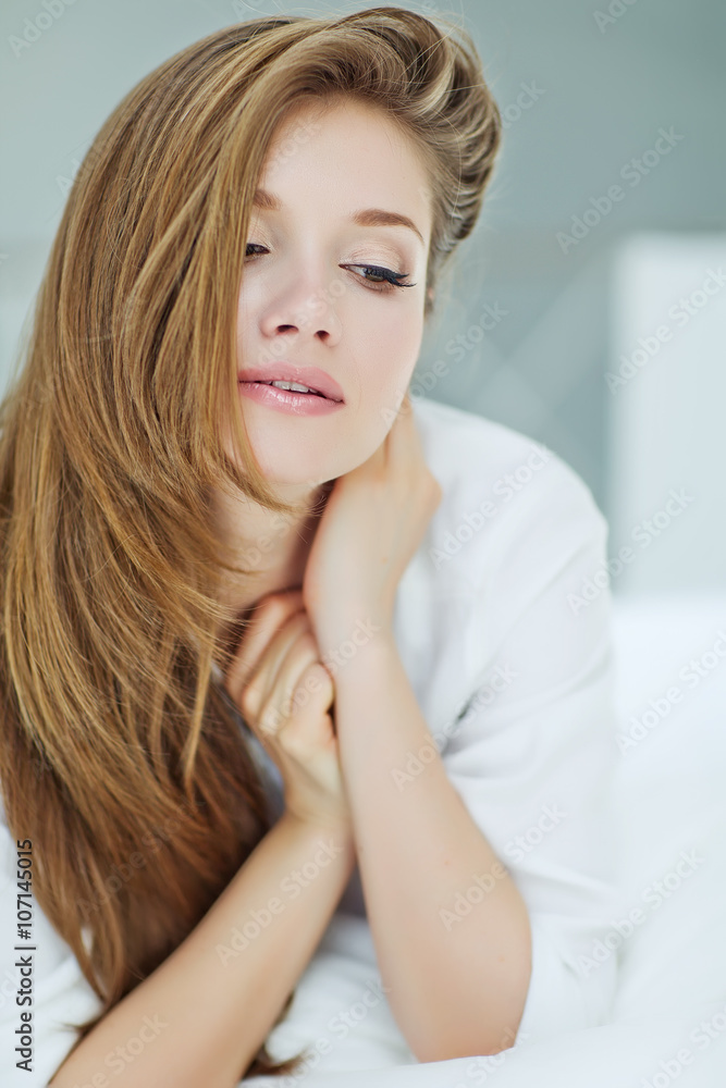 Portrait of a beautiful woman in the morning bed 
