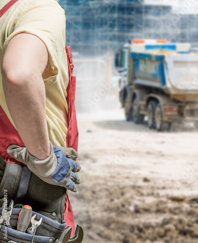 Worker in uniform and building truck