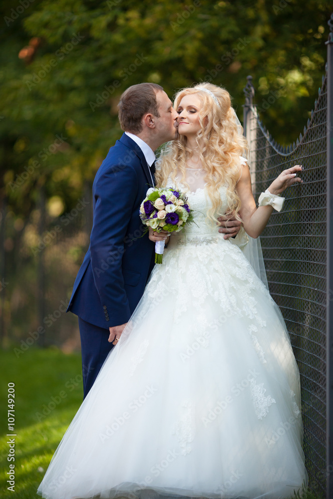 elegant stylish groom with his happy gorgeous blonde bride on th elegant stylish groom with his happy gorgeous blonde bride on th