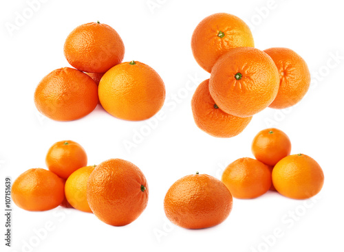 Piles of multiple ripe fresh juicy tangerines, isolated over the white background