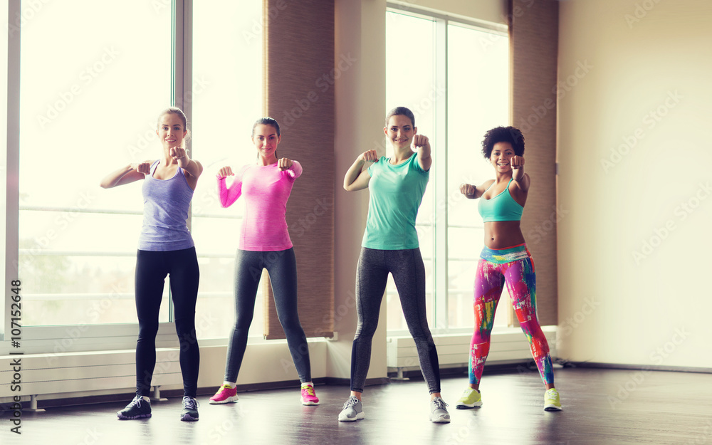 Fototapeta premium group of happy women working out in gym