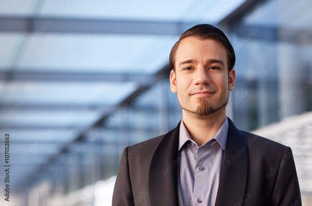 Portrait of a neat and stylish young businessman looking positiv Portrait of a neat and stylish young businessman looking positiv