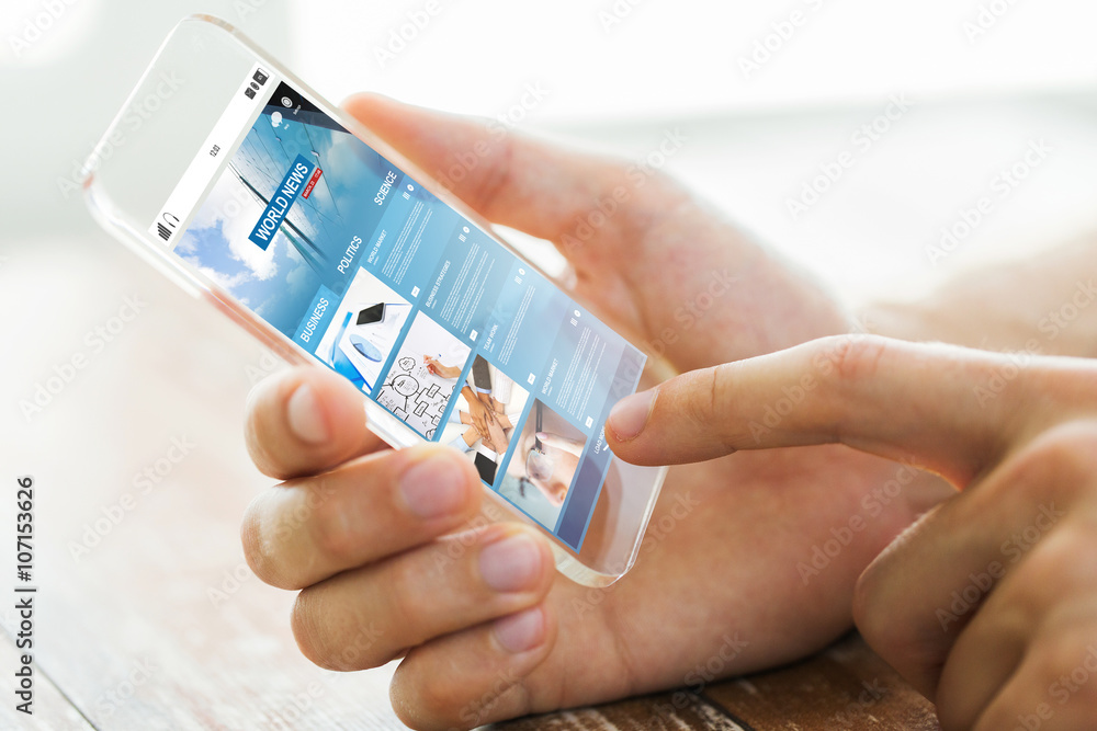 close up of male hand with world news smartphone close up of male hand with world news smartphone