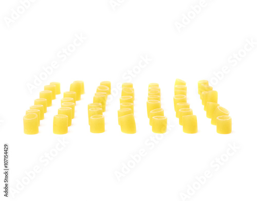 Single pieces of dry ditalini pasta over isolated white background