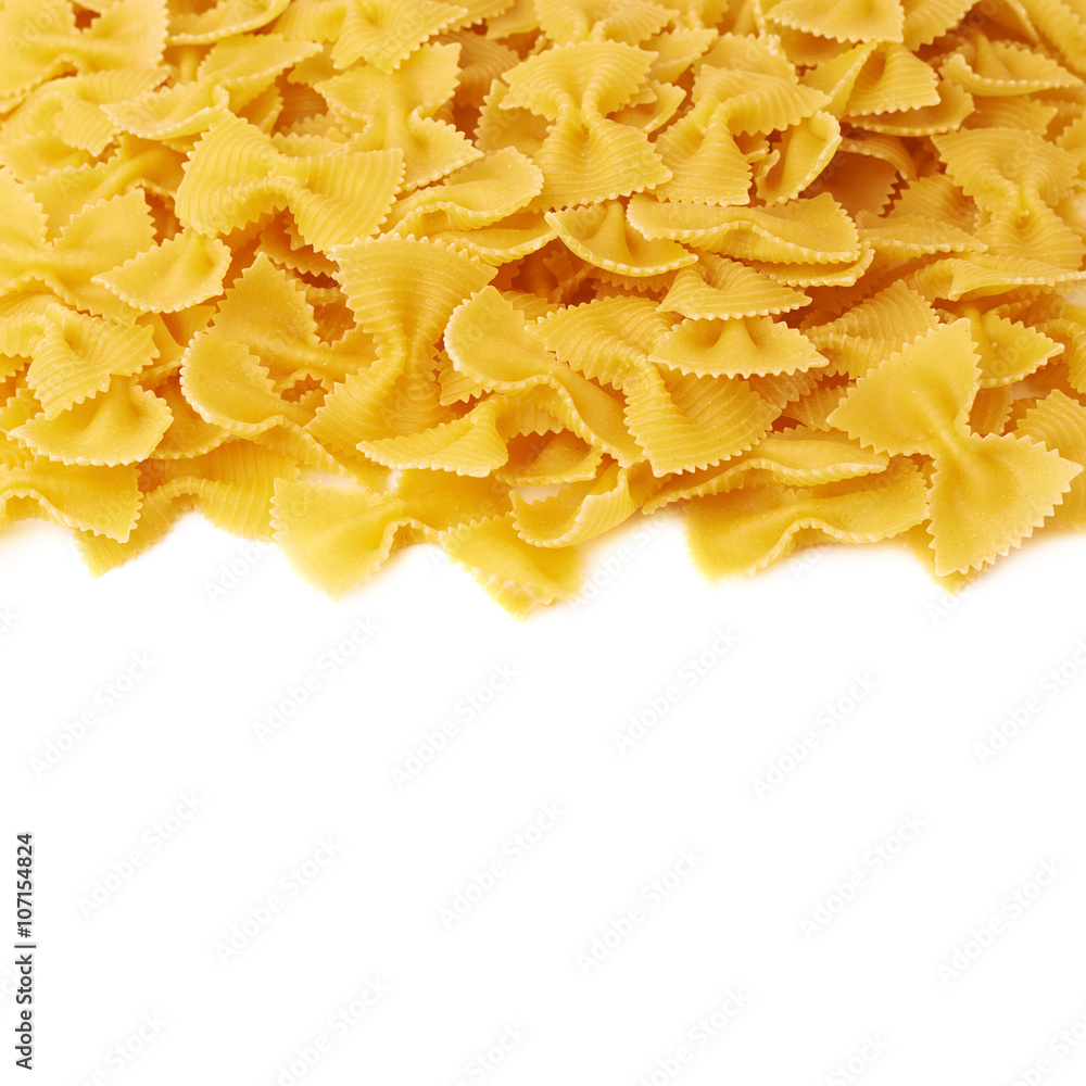 Pile of dry farfalle pasta over isolated white background Pile of dry farfalle pasta over isolated white background