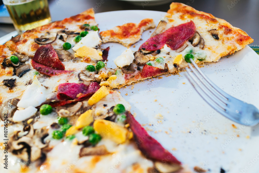 Sliced pizza with different ingredients Sliced pizza with different ingredients