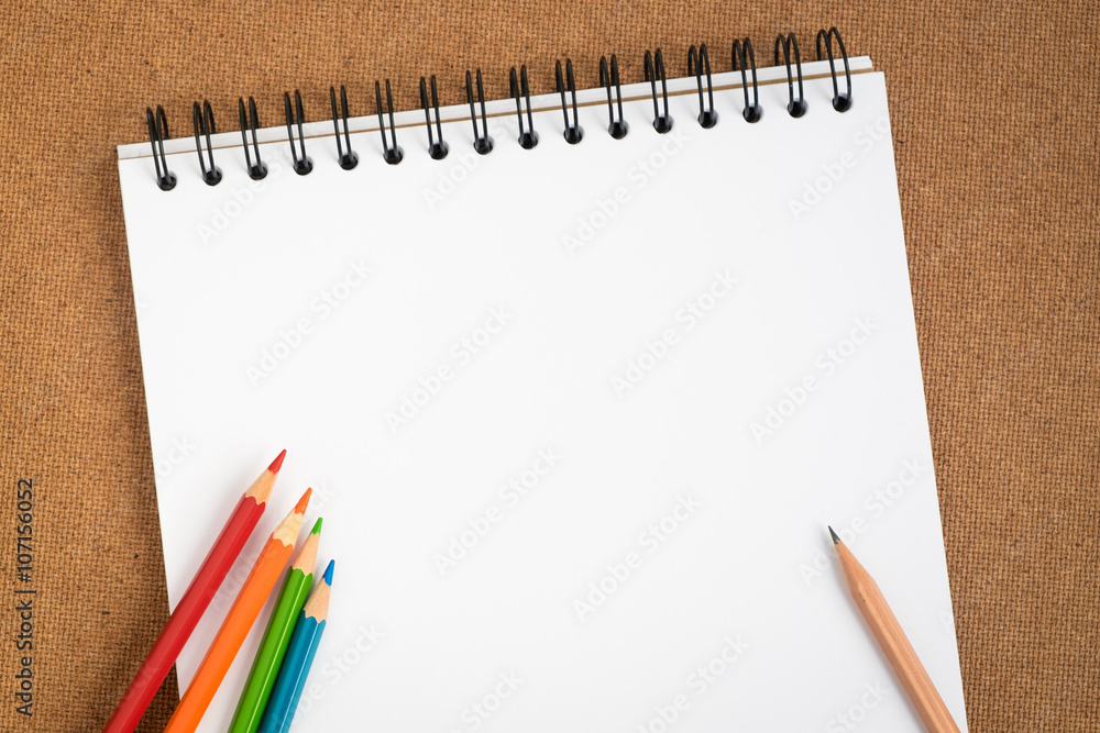 Open spiral sketchbook with colored pencils Open spiral sketchbook with colored pencils