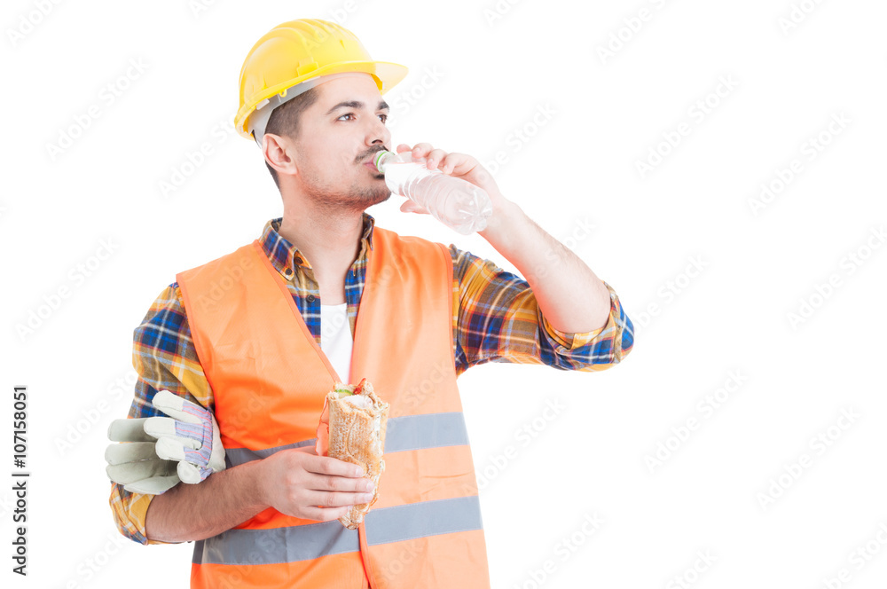 Portrait of young engineer eating a sandwich and drinking water Portrait of young engineer eating a sandwich and drinking water