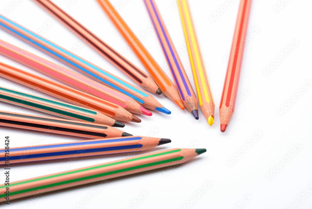 Close up picture of colored pencil crayons with stripes on white Close up picture of colored pencil crayons with stripes on white