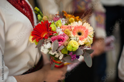 Fototapeta Naklejka Na Ścianę i Meble -  bride dressed in national dress holding a beautiful wedding bouq