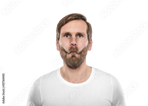 Man in white T-shirt grimaces. photo