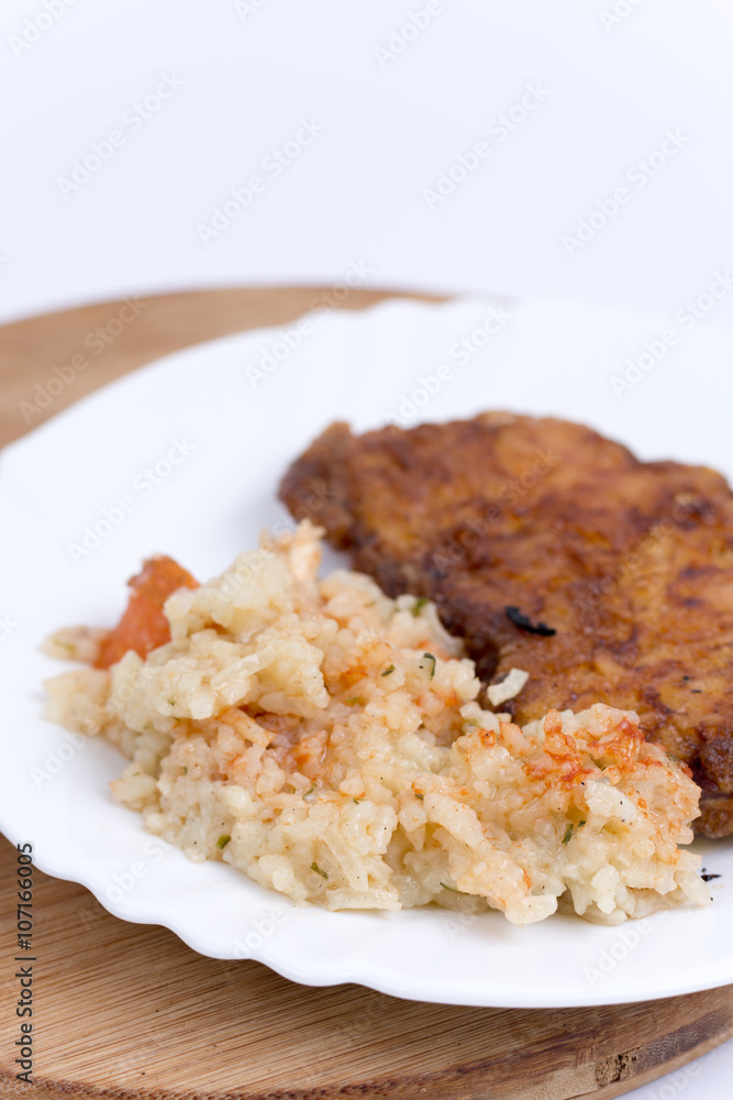 Breaded meat with cooked rice with vegetables Breaded meat with cooked rice with vegetables