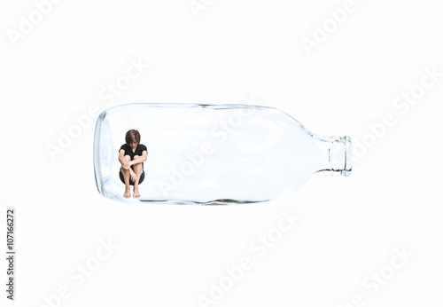 Asian woman sitting in the glass bottle.