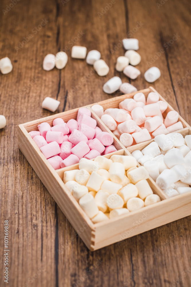 Box with marshmallows on the wooden background Box with marshmallows on the wooden background