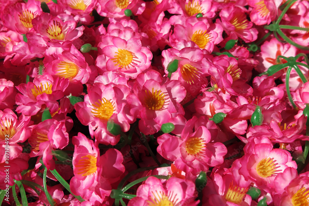 Obraz premium Pink tree artificial flowers laying under the tree