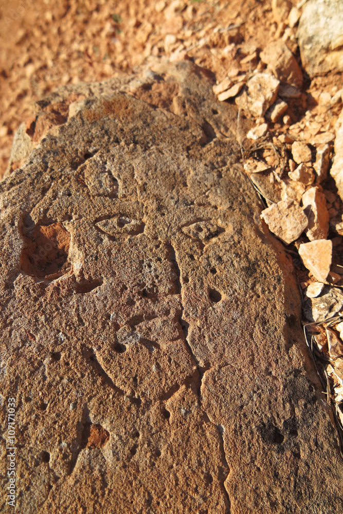 Prehistoric engraved stone face imitation Prehistoric engraved stone face imitation