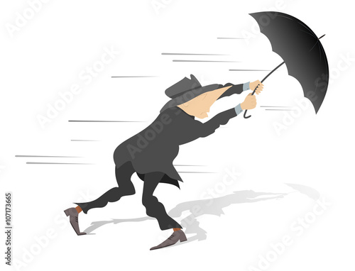 Windy day. Man tries to hold an umbrella gone with the wind
