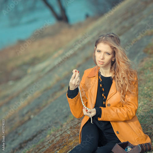 ordinary girl nostalgic with casket. Adult girl recollects childhood photo