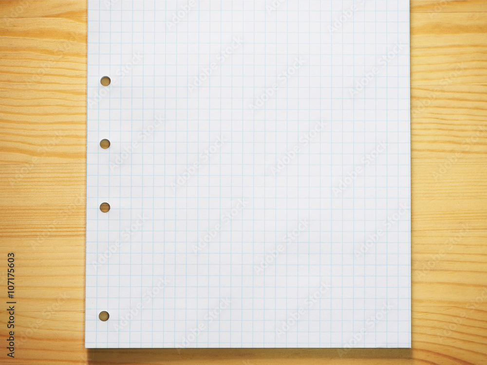 Blank graph paper on wood background Blank graph paper on wood background