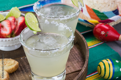 Fotografie Classic margarita cocktail garnished with salt rim,  lime wheel.