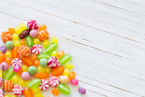 variety of candies on a wooden background