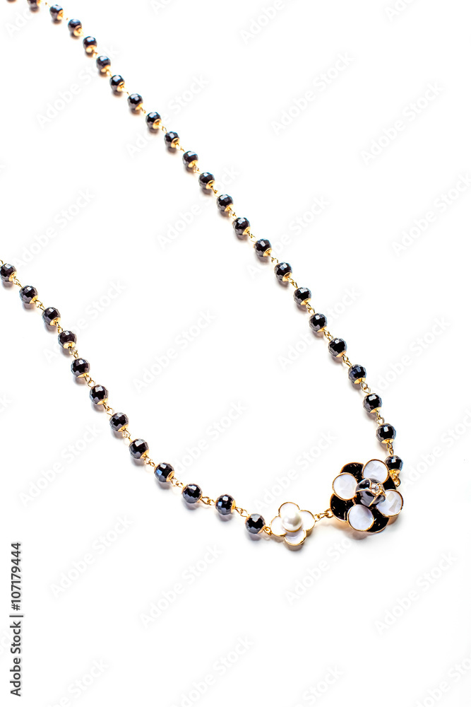 necklace with flower and black beads isolated close up necklace with flower and black beads isolated close up