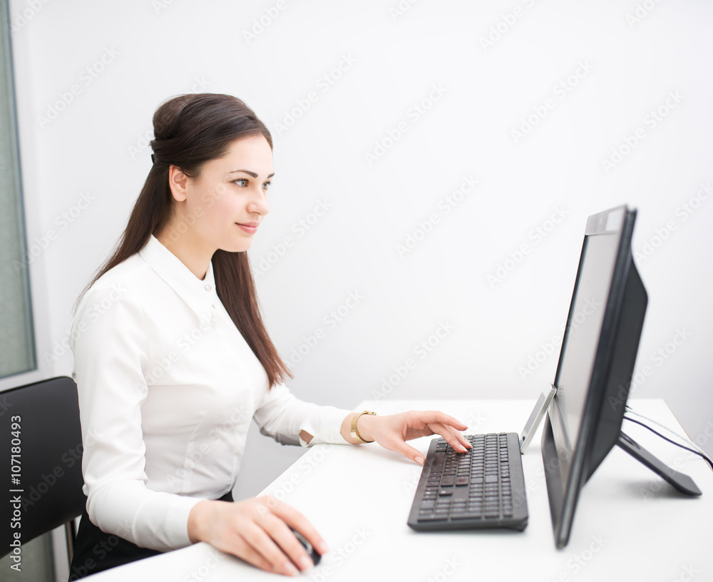young business woman working with a computer in the office young business woman working with a computer in the office
