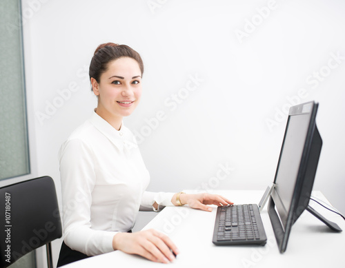 smiling young business woman working in the office