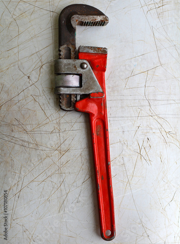 red screw-wrench on a metal background photo