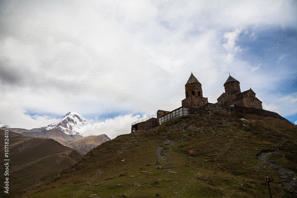 Gergeti christian church near Kazbegi, Stepancminda village in Georgia, Caucasus.