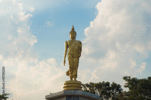 Golden buddha statue with blue sky