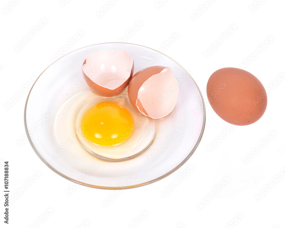 Cracked brown eggs on plate separated on white background Cracked brown eggs on plate separated on white background