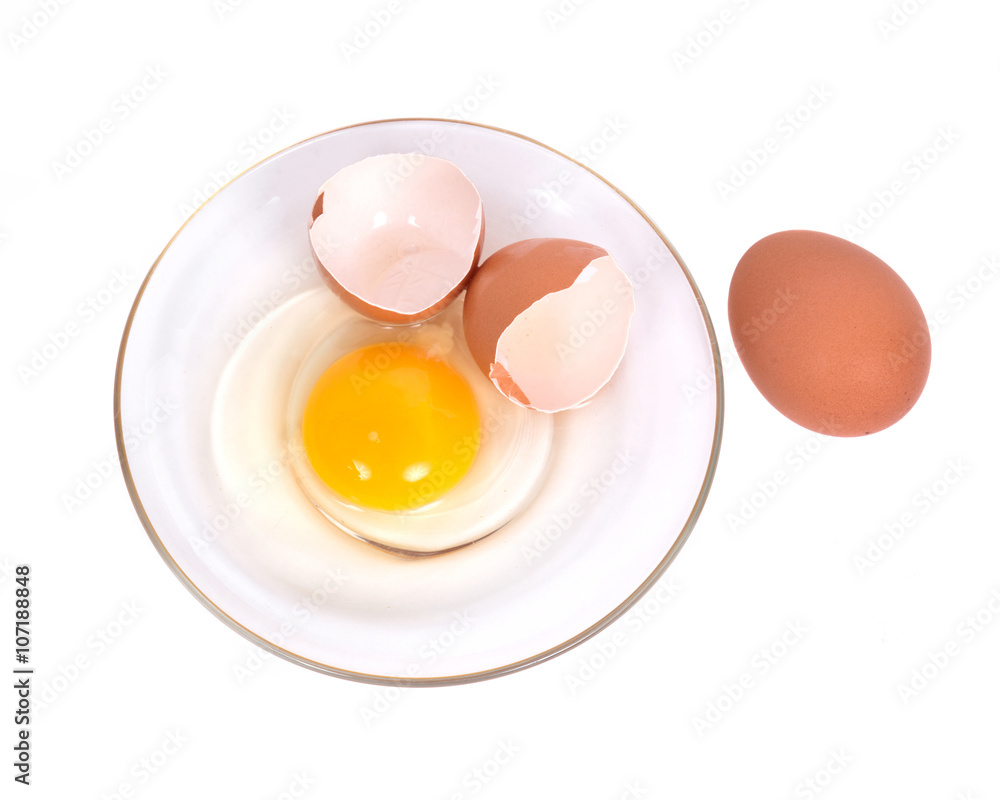 Cracked brown eggs on plate separated on white background Cracked brown eggs on plate separated on white background