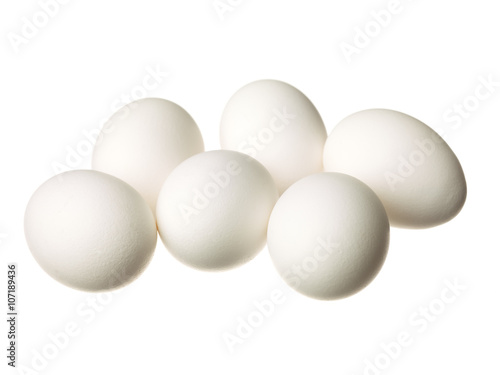 half dozen eggs displayed on white