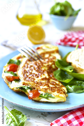 Omelet with tomato and spinach.