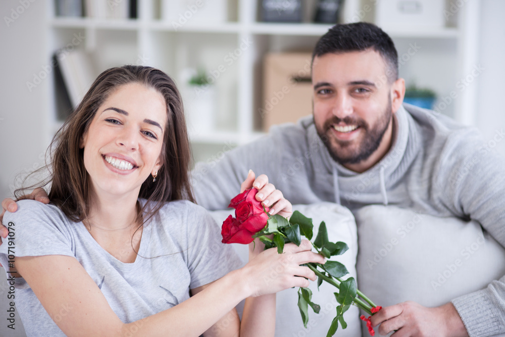 Young man giving a red rose to his girlfriend Young man giving a red rose to his girlfriend