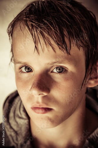 Fotografie Thoughtful solemn young boy with wet hair