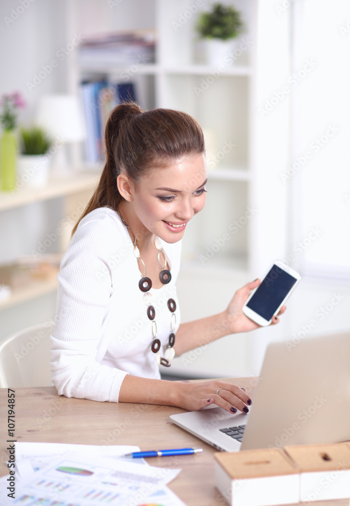 Young businesswoman sitting and talking on phone Young businesswoman sitting and talking on phone